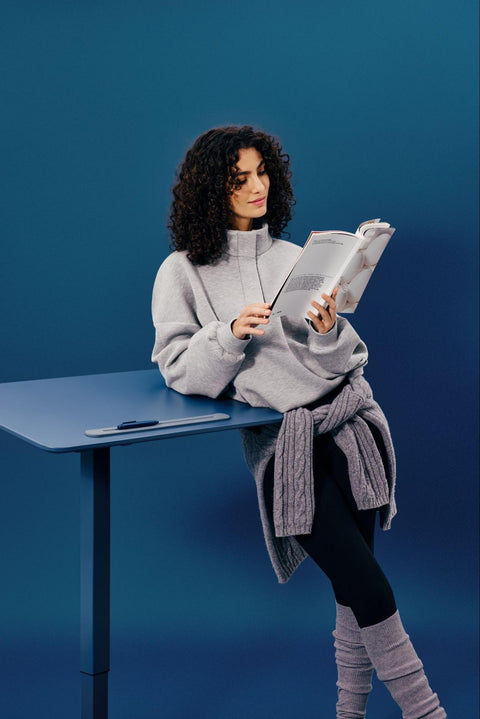 Woman Reading Book while Leaning on the AnyDesk Fold by TopJob